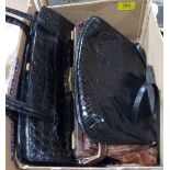 Three vintage leather handbags, starched cuffs and collars, ebonised glove stretchers etc.