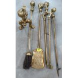 A four piece brass set of fire irons with ball and claw terminals, together with an andiron