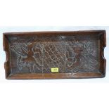 An antique oak tray, carved with a pair of wyverns 21' wide. Adapted from an early panel
