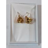A pair of trilliant cut yellow tourmaline earrings. In gold marked 375. 1.2g