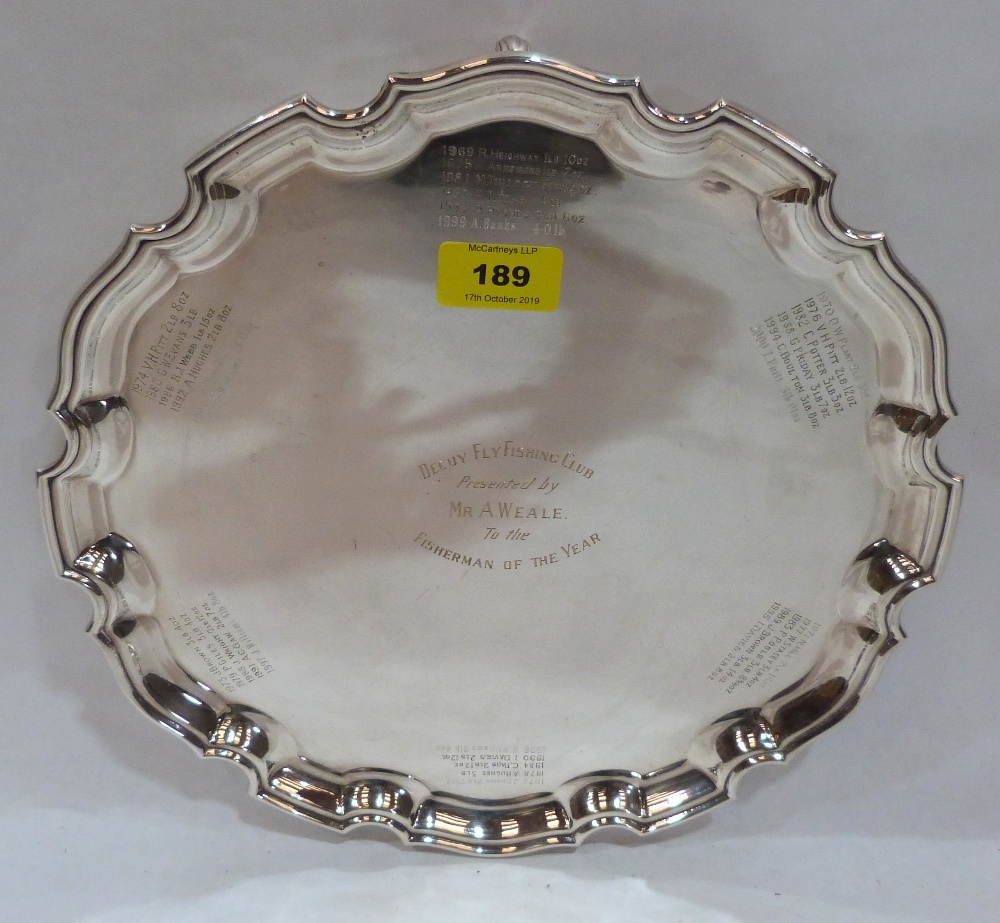 A plated salver with fly fishing engraved inscriptions. 12' diam.