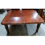 A Victorian mahogany dining table on turned and fluted legs, screw extending to 92' with two extra