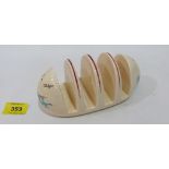 A Beswick 'Circus' pattern toastrack. 6¼' wide.