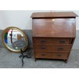 An Arts and Crafts style oak bureau, a gilt wall mirror and a japanned wine table