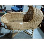 A wicker crib on bamboo stand