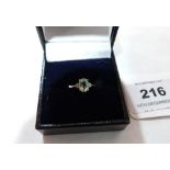A green tourmaline and white stone ring. In white gold marked 375. Size N½. 1.8g gross
