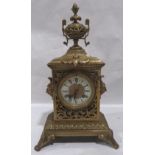 A French gilt brass mantle clock, the pierced cast case surmounted by an urn, the 8 day drum