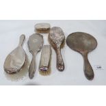 Four silver backed brushes and two silver hand mirrors