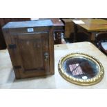 A joined oak wall cupboard and a gilt gesso mirror