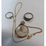 A pendant on necklet chain, painted to both sides with a portrait of a young boy, together with a