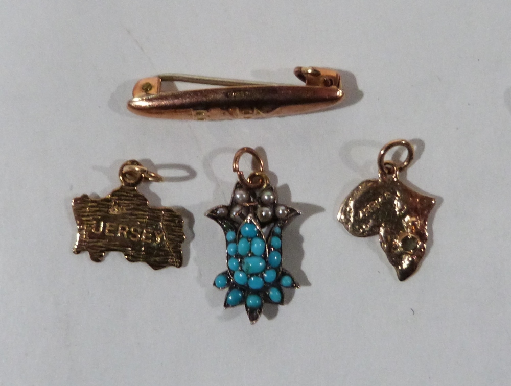 Three gold pendants and a gold 'Baby' brooch. 4.5g gross