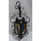 A wrought iron and stained glass hall lantern