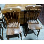 A George III oak gateleg dining table and two Victorian stickback kitchen chairs