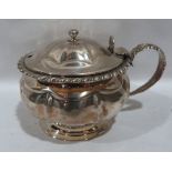 A George IV silver jam pot with gadrooned rim and frosted glass liner. London 1823. 3½' diam. 5ozs