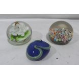 A close cane millefiori paperweight and two others