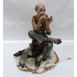 A Capodimonte style figure of old man with cat. 9½' high