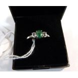 A green and white three stone ring. In silver marked 925. Size P½