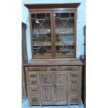 A Victorian pitch pine bookcase on chest, the associated upper part enclosed by a pair of astragal