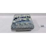A Chinese ceramic blue and white box and cover painted with figures in a garden. 4' wide