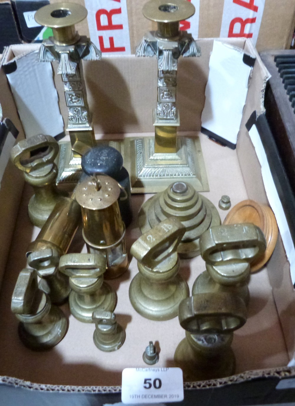 A collection of sovereign weights, other weights and brassware