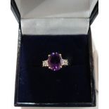 An amethyst and white stone ring. In gold marked 375. Size N½. 2.2g gross