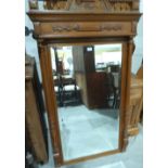 A Victorian oak looking glass with bevelled plate. 62' x 36'