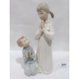 A Lladro group of two praying children. 8¾' high