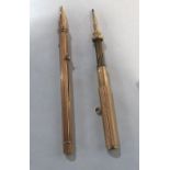 A gilt metal propelling pen/pencil and a propelling pencil