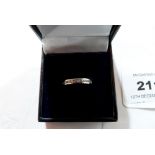 A channel set white stone ring. In white gold marked 375. Size K. 2.3g gross