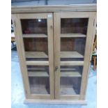 A pine cupboard enclosed by a pair of glazed doors. 40' wide