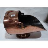 A copper helmet coal scuttle