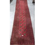 A red ground carpet runner. 118' x 32'