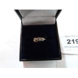 A three stone diamond ring. In gold. Size O. 1.9g gross