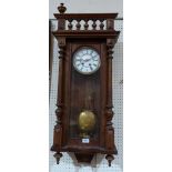 A walnut Vienna wall clock, the two train movement striking on a coiled gong. 40' high