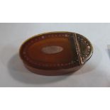 An 18th century pressed horn and gold pique oval snuffbox. 2¼' long. Hinge pin A.F.