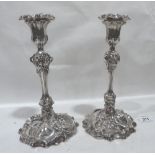 A pair of Victorian silver rococo revival candlesticks. Sheffield 1838. 10¾' high. Loaded