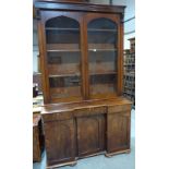A Victorian mahogany library bookcase enclosed by a pair of glazed doors, the base of inverted