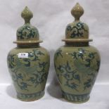 A pair of oriental inverted baluster jars with domed covers, decorated with birds and scrolling