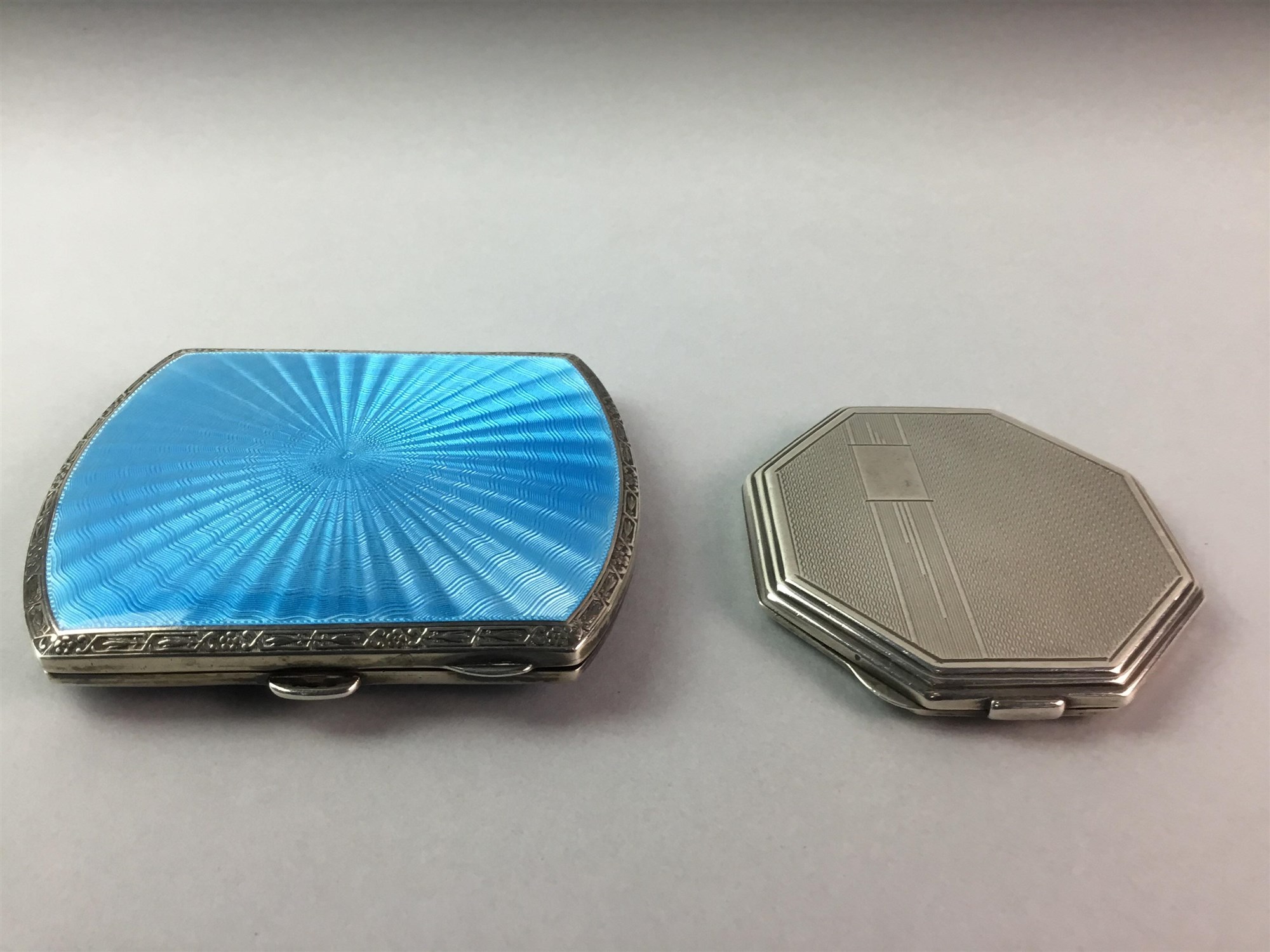 A SILVER AND BLUE ENAMEL CIGARETTE CASE AND A SILVER COMPACT