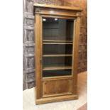 A REPRODUCTION GLASS DOOR CABINET