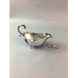 A SILVER CIGAR CUTTER AND A SILVER GRAVY BOAT
