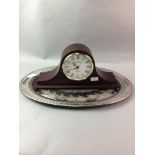 A SILVER PLATED SERVING TRAY AND A MANTEL CLOCK