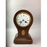 AN EDWARDIAN MAHOGANY BALLOON SHAPED CLOCK