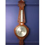 AN EDWARDIAN WHEEL BAROMETER AND THERMOMETER
