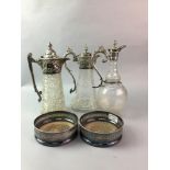 A PAIR OF SILVER PLATED WINE SLIDES AND THREE CLARET JUGS