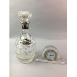A SILVER COLLARED CRYSTAL DECANTER AND A CRYSTAL CLOCK
