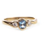 A BLUE GEM AND DIAMOND THREE STONE RING