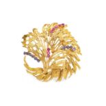 AN EIGHTEEN CARAT GOLD GEM SET BROOCH