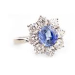 A SAPPHIRE AND DIAMOND CLUSTER RING