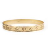 A NINE CARAT GOLD BANGLE